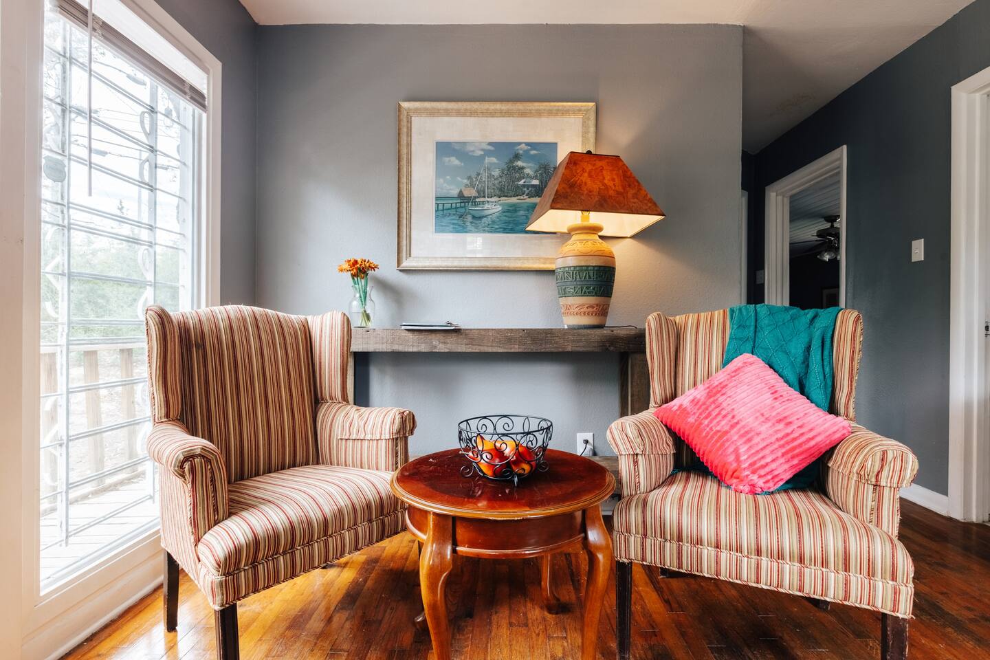 cozy living room with 1 couch 2 chairs sits 5.  Facing a park with a lot of natural lights