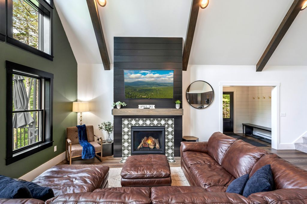 Modern rustic charm.  The sleek TV contrasts beautifully with the warm wood tones and the unique fireplace surround.