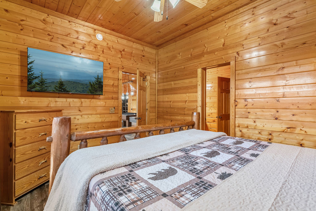 Rest easy in a cozy king bed, where mountain mornings begin with treetop views&mdash;this room shares a full bathroom with the nearby bunk room, perfect for families or close friends.