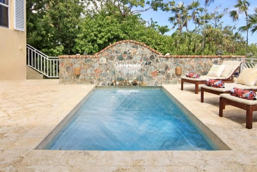 Spacious pool deck with sun loungers and tropical greenery—perfect for all-day lounging and dips.