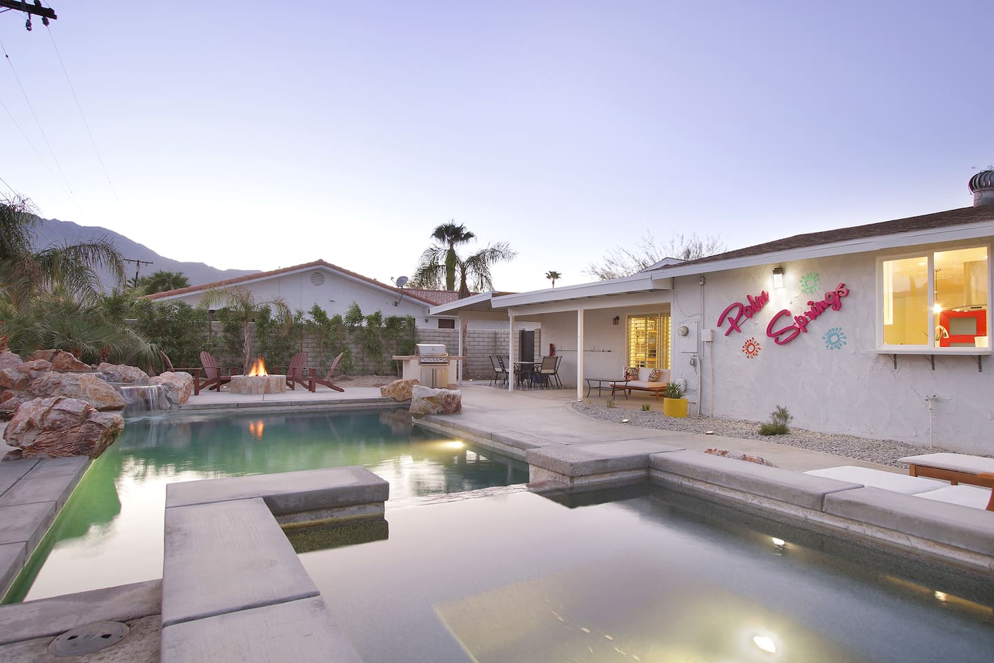 Large hot tub/spa with large pool and waterfall features
