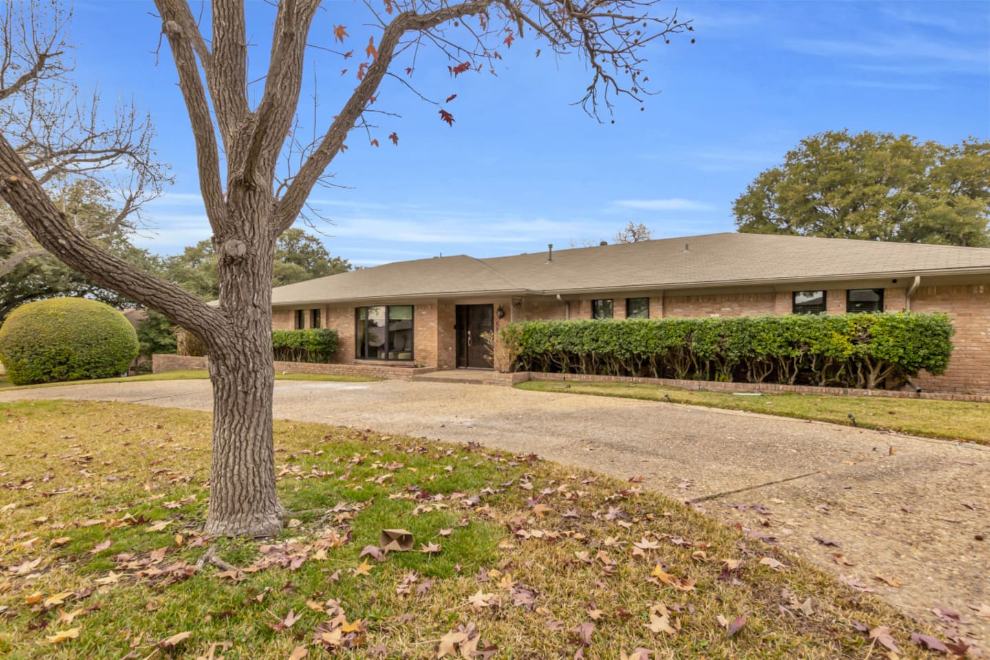 Classic Dallas home with a welcoming front entry and circular driveway, combining timeless architecture with convenient access and ample parking.