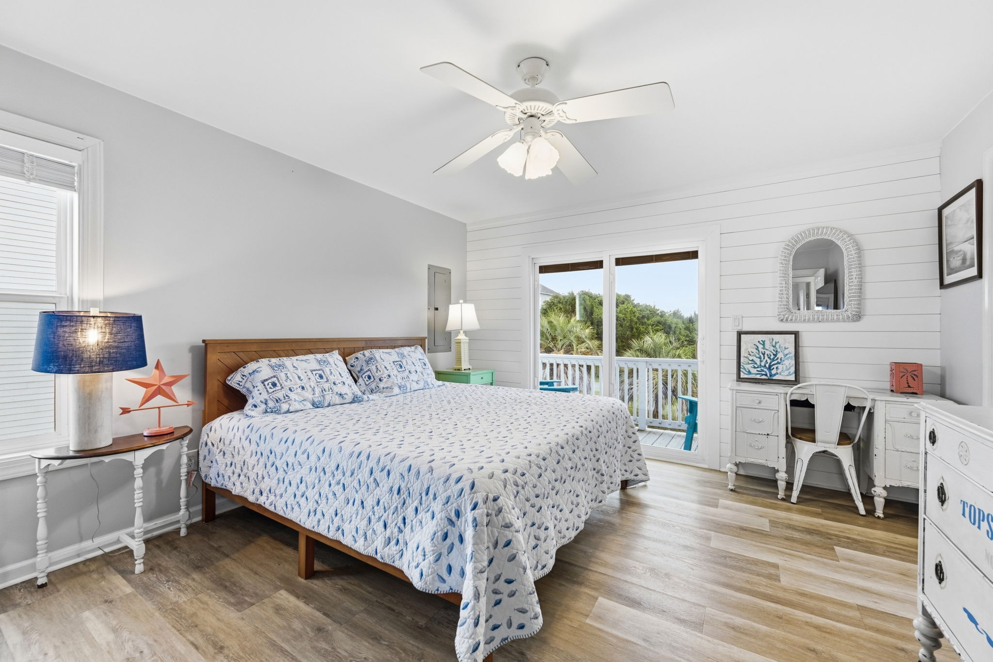 King suite featuring a ceiling fan, ample storage, work desk, and private deck access for added comfort and convenience.