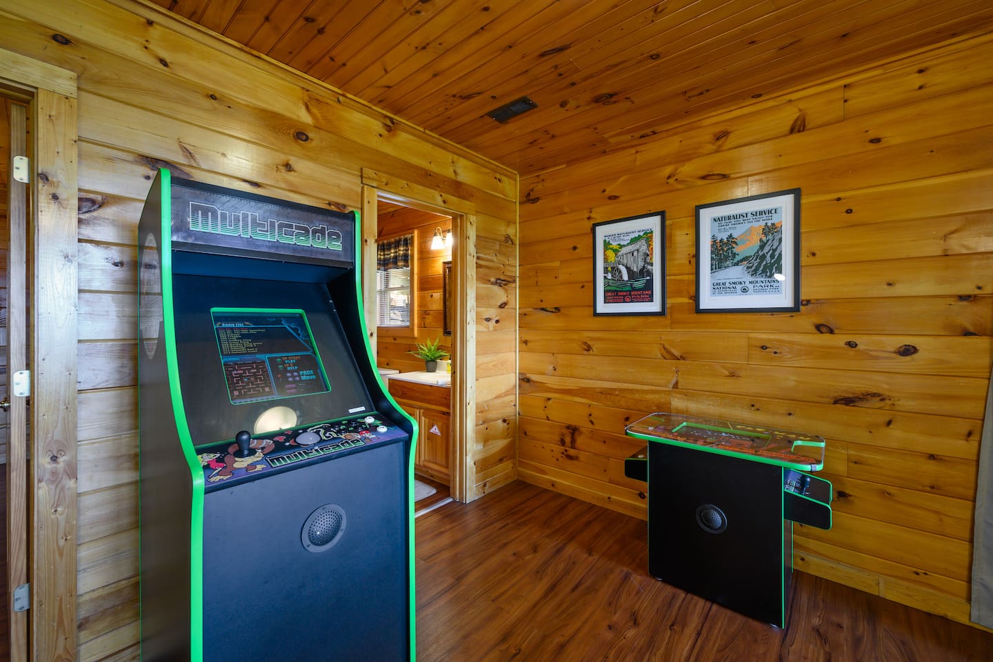 Two multicade games loads of games to choose from to play.  Also shown is access to the shared bathroom from the game room.