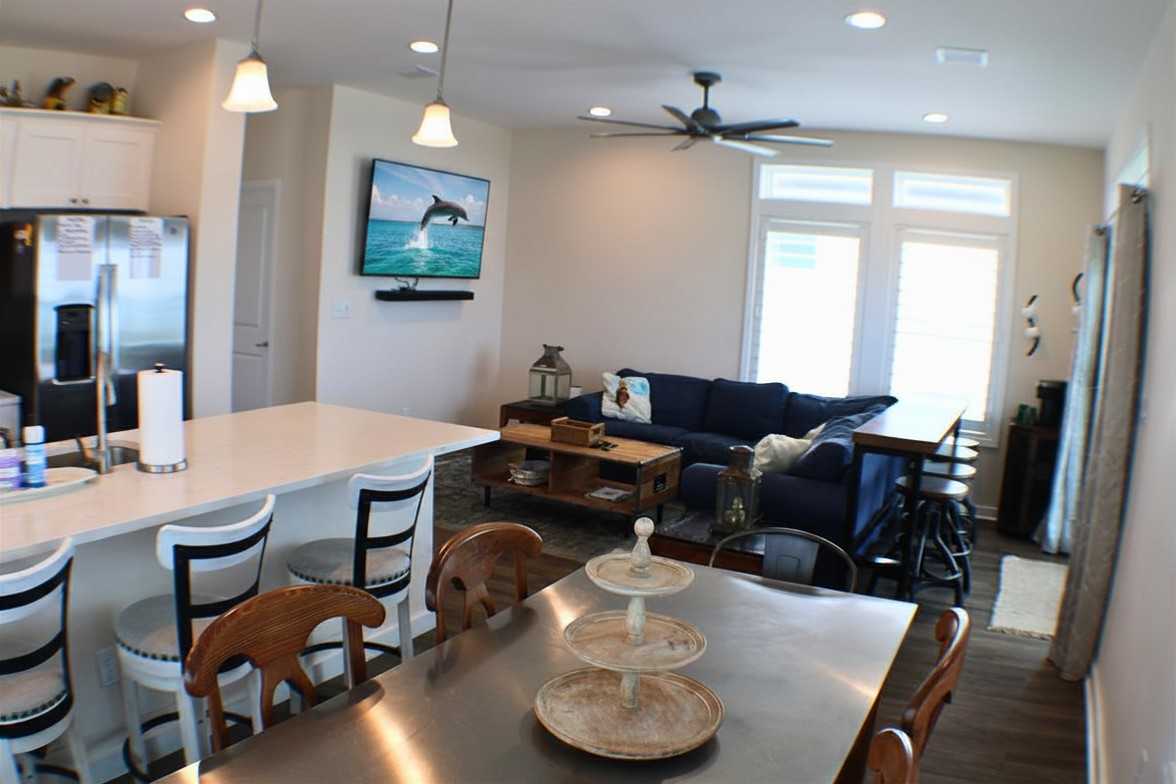 Living Room: Bright and airy space with a plush couch, ideal for relaxing after beach adventures!