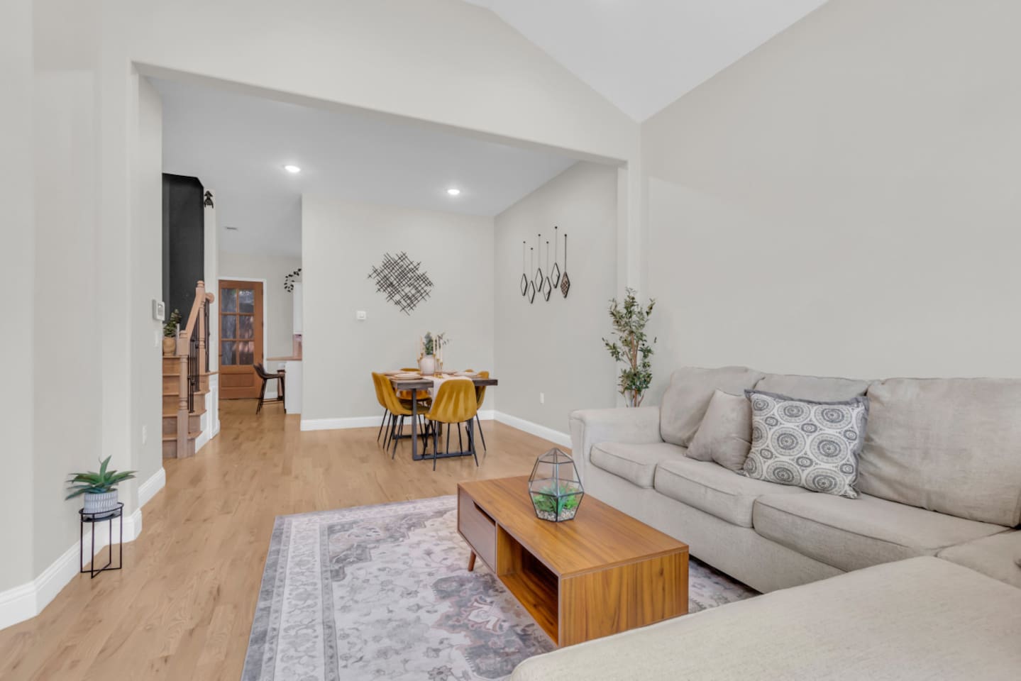 Spacious living room with vaulted ceilings and natural light.