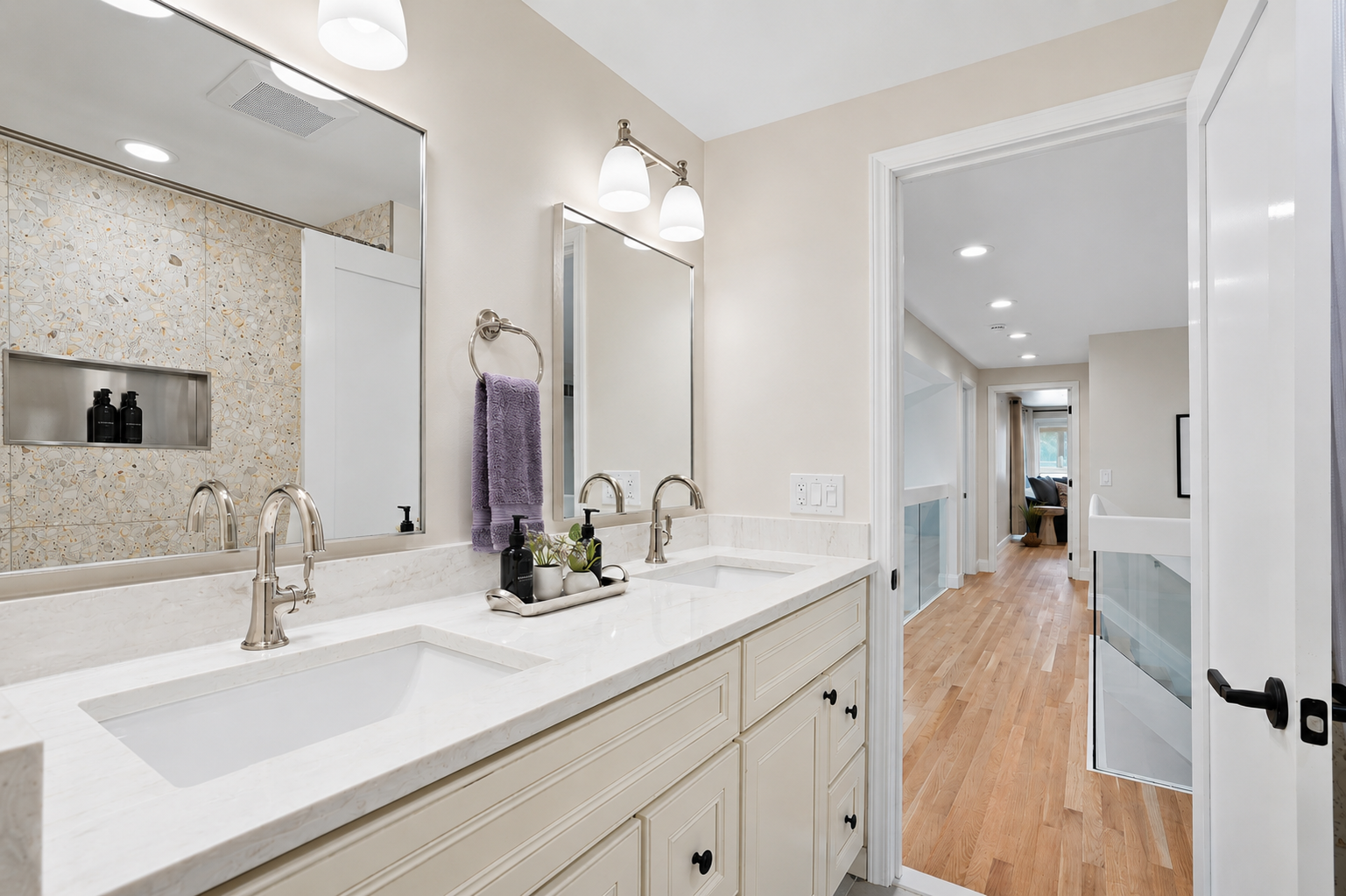 Bright, modern double vanity bathroom with quartz countertops, polished fixtures, and clean neutral finishes. Spacious, well-lit design with a fresh, hotel-like feel for a comfortable stay.