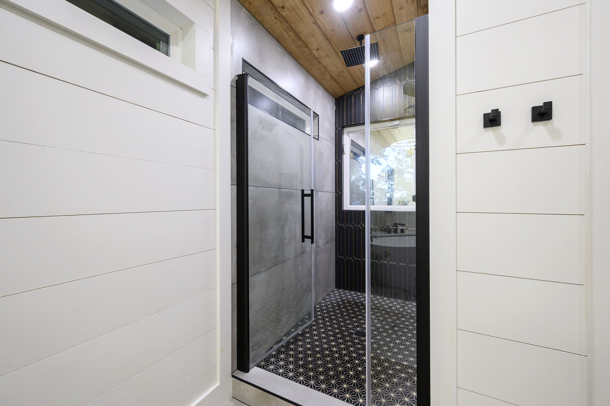 Luxury bathroom featuring a walk-in rain shower and inviting soaking tub.