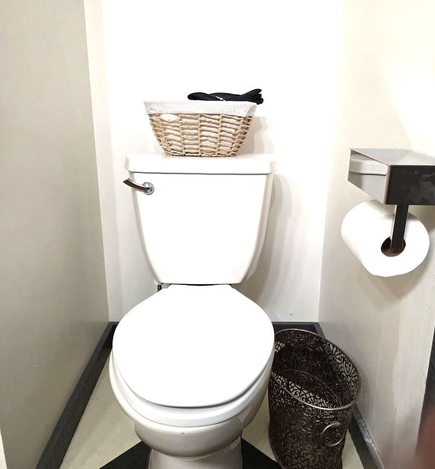 Downstairs bathroom with tub/shower, double sinks and toilet