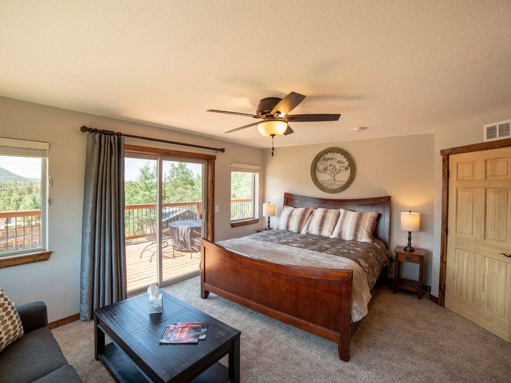 Upstairs Bedroom 2 with luxurious king bed with amazing picture window views. Enjoys direct access to the deck.
