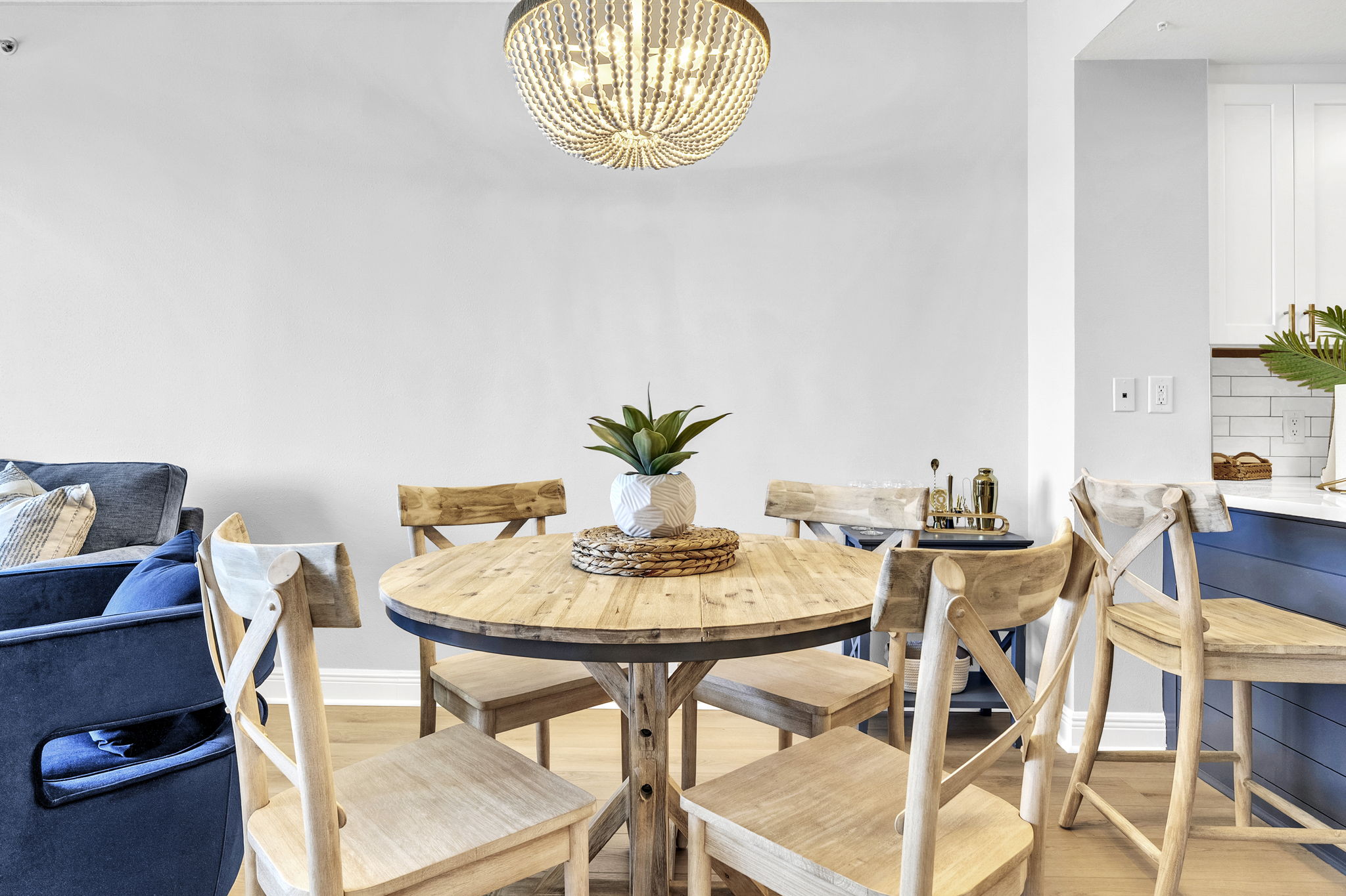 Gather around the table in this warm, coastal-inspired dining space—perfect for family meals, game nights, and planning your next beach day.