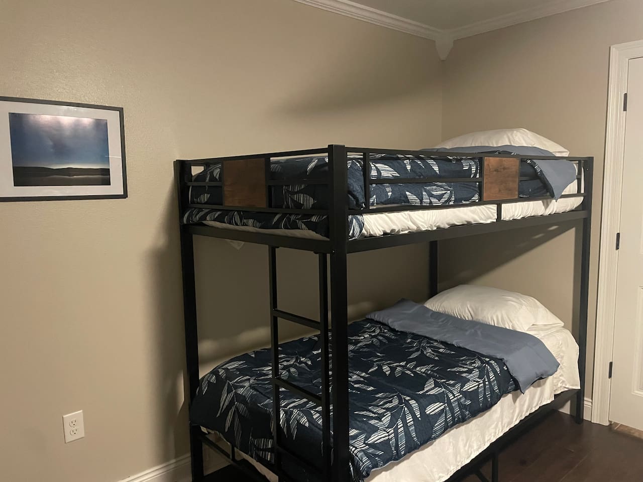 Bedroom with queen and twin bunks.