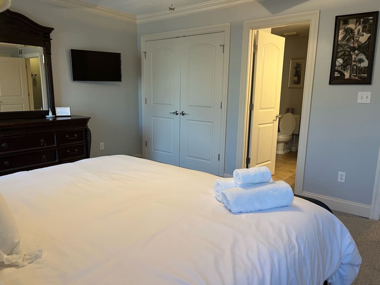 View of the bathroom from the bed, creating a seamless and open layout that enhances the spacious feel of the room.