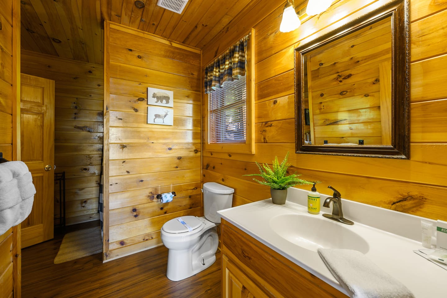 Shared bathroom on the lower level with oversized shower stall, toilet and vanity. 