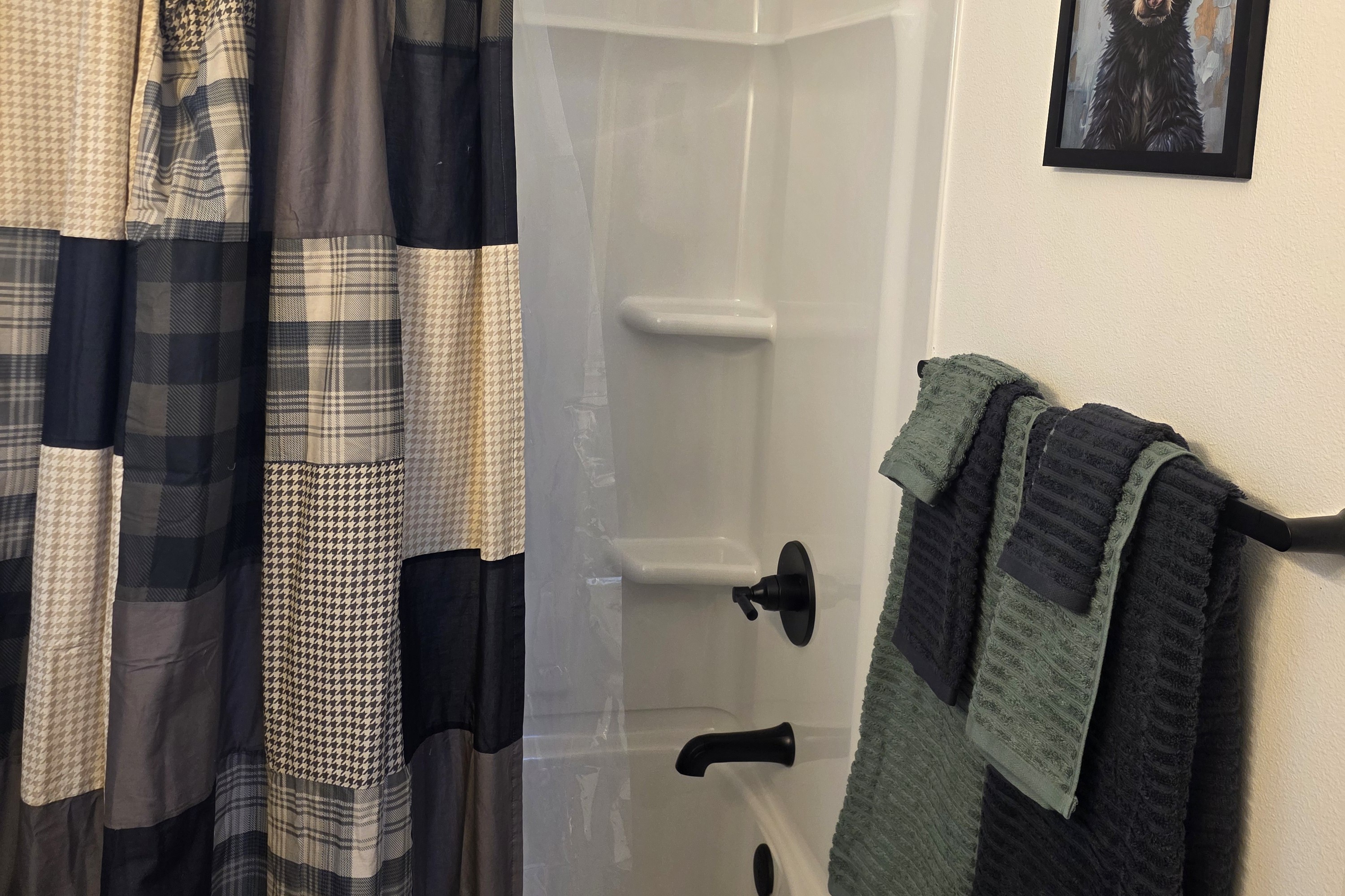 Bathroom includes a vanity, toilet, and shower/tub combo.