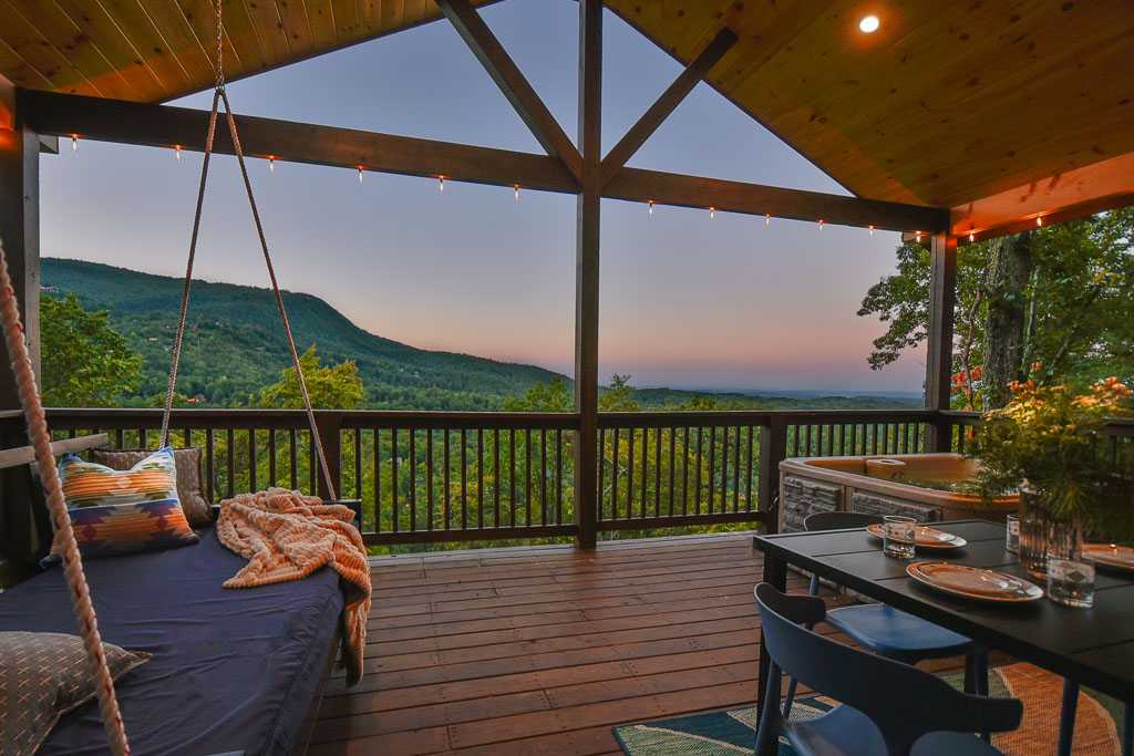 Outdoor dining, bed swing, corn hole, the hot tub and a 55 in TV make the back deck the place to be!