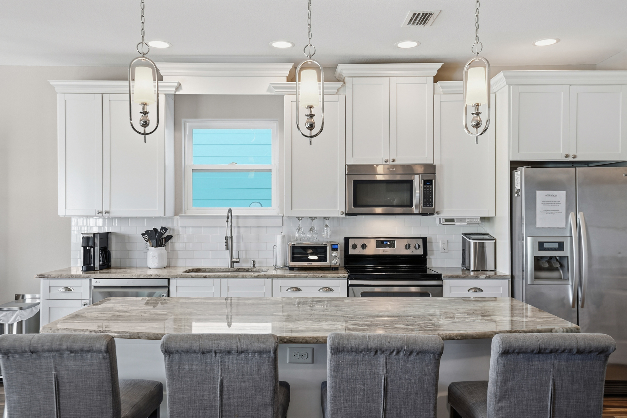 Bright open floor plan connects the kitchen, dining and living spaces for group getaways.