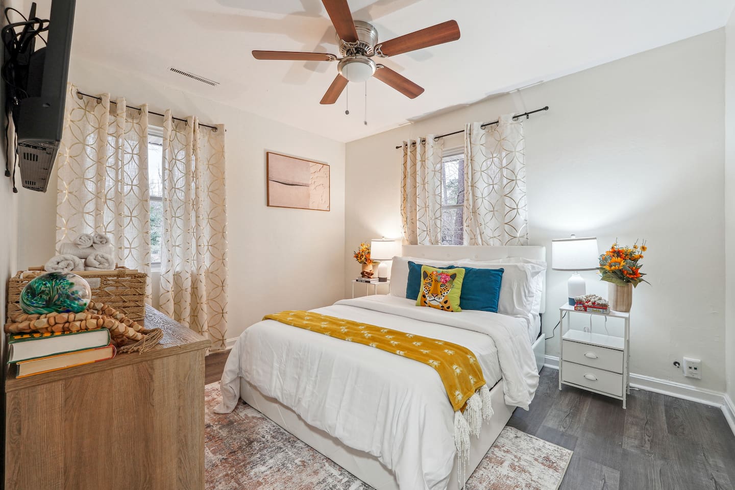 A cozy bedroom with a Queen bed, ceiling fan, TV, bedside lamp, and a spacious closet to keep your belongings organized.
