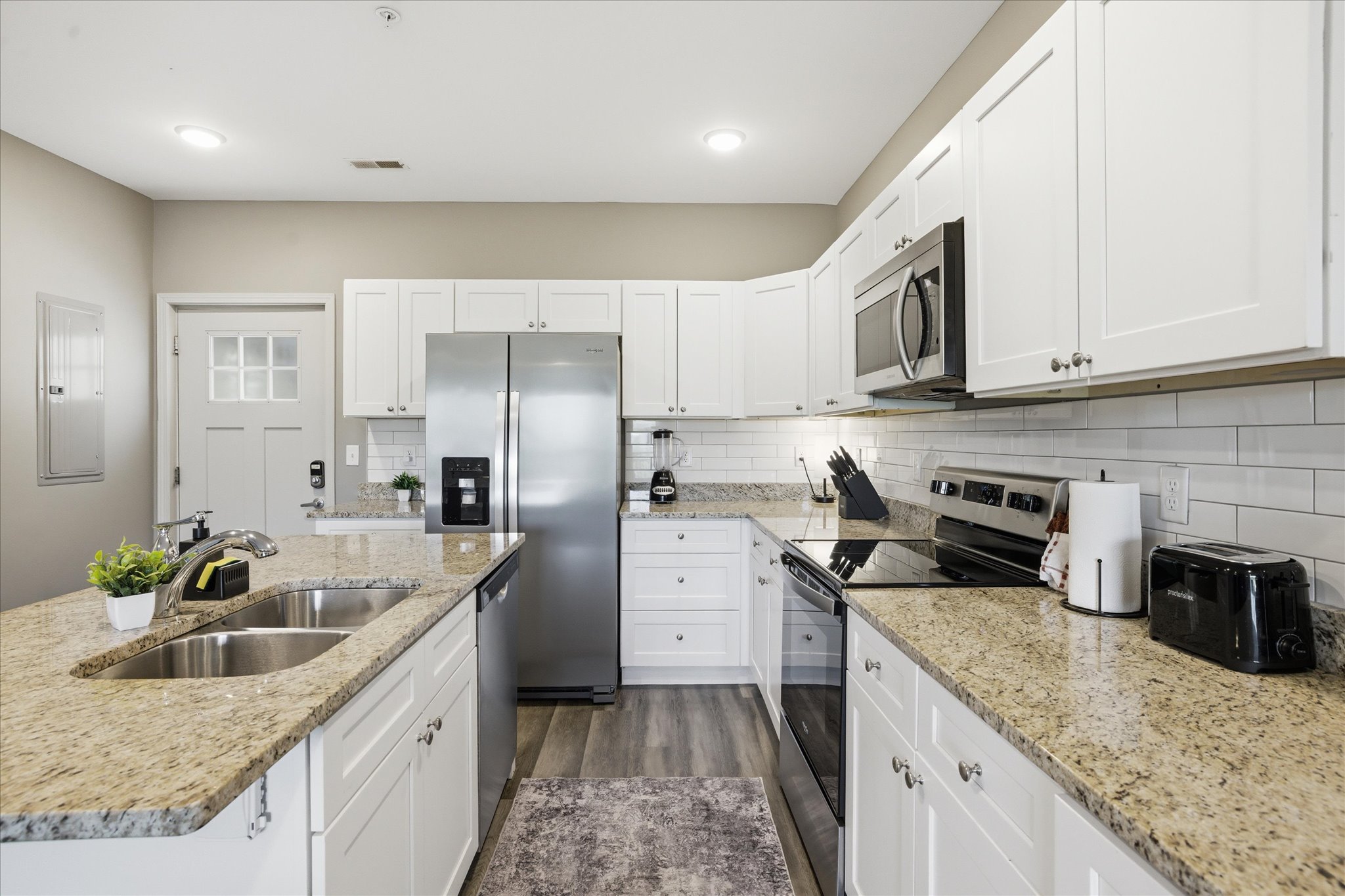 Unit 1’s kitchen is ready for real use—ample counter space, stainless appliances, and a layout that lets you prep, cook, and stay part of the conversation the entire time.