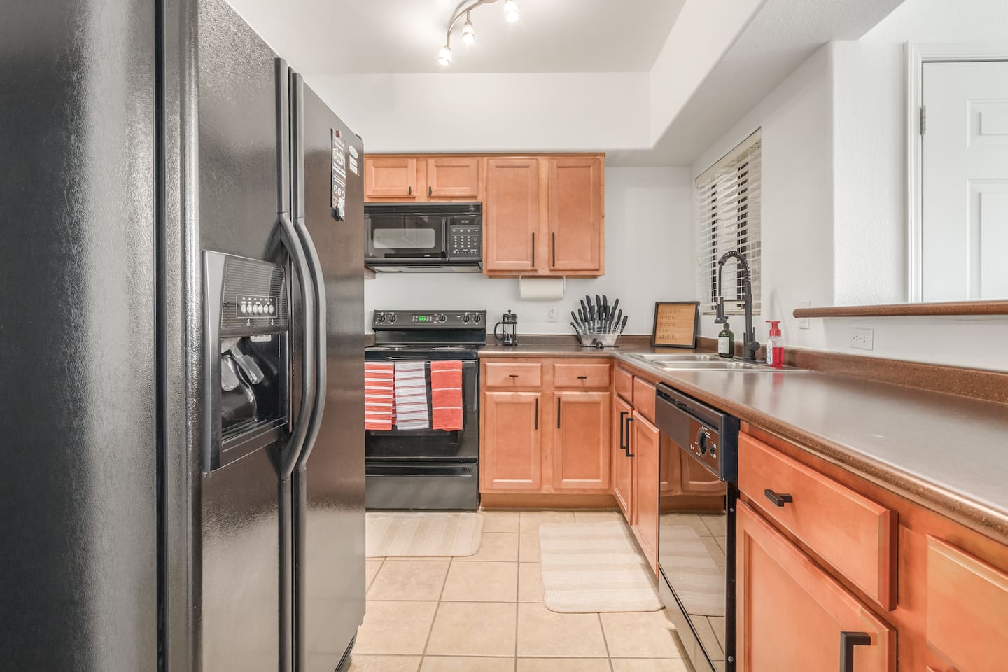   Kitchen with full-size fridge, stove, dishwasher, and plenty of counter space for daily use