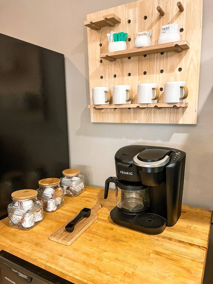 Fully stocked coffee bar. Includes: k cups coffee, k cup decaf, k cup hot chocolate, tea bags, sugar, and creamer.