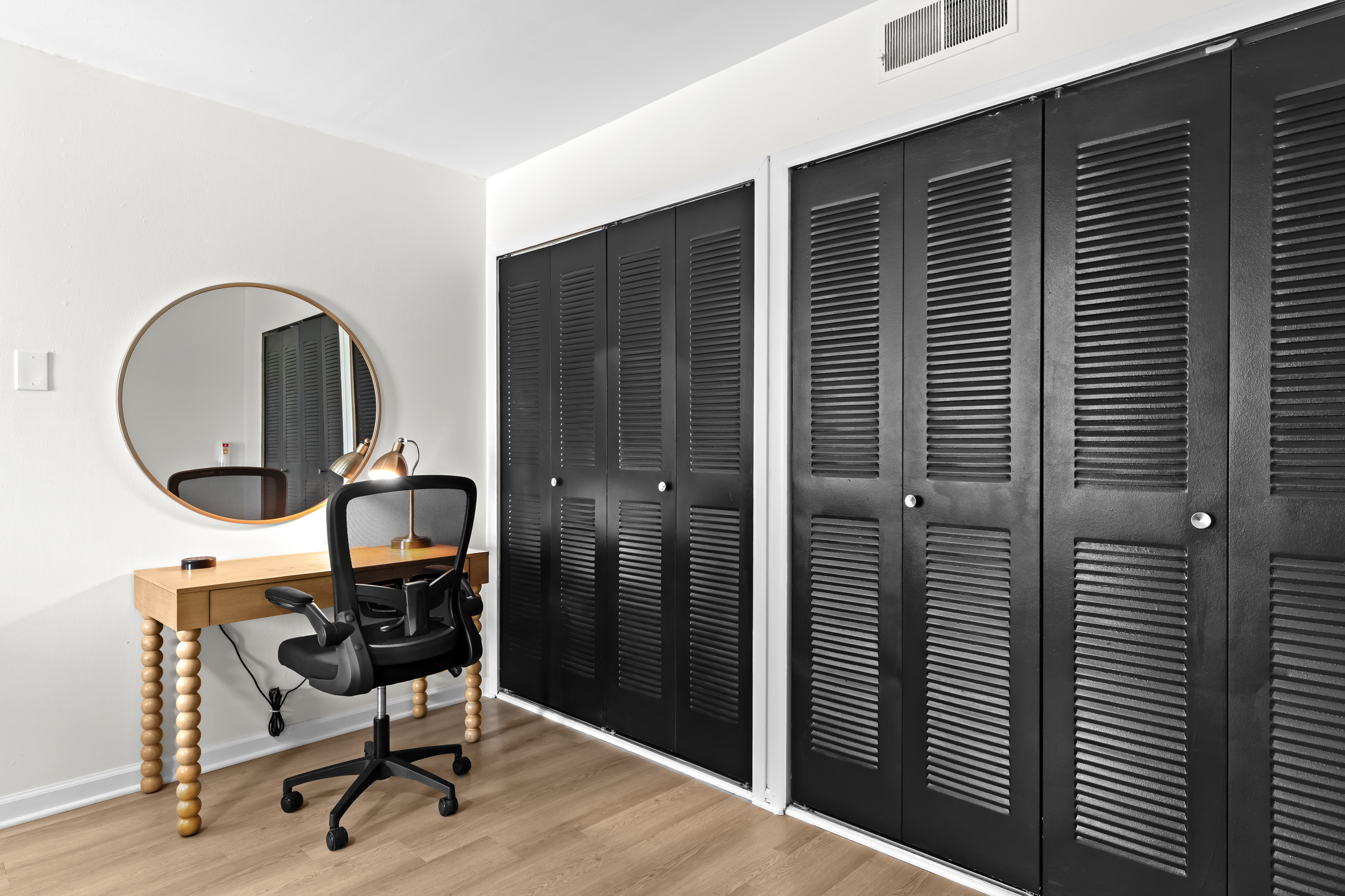 Functional setup with a desk, chair, and ample closet space for extended stays.