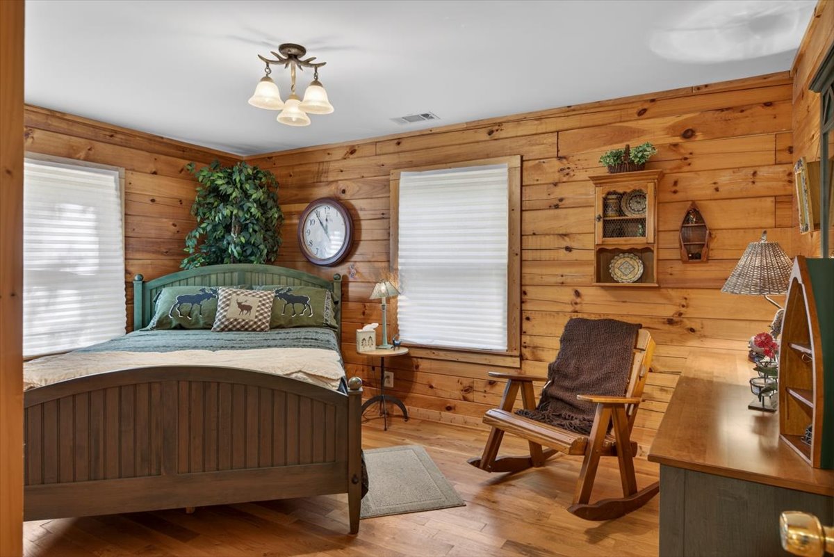 Inviting queen bedroom with warm cabin charm and restful vibes.