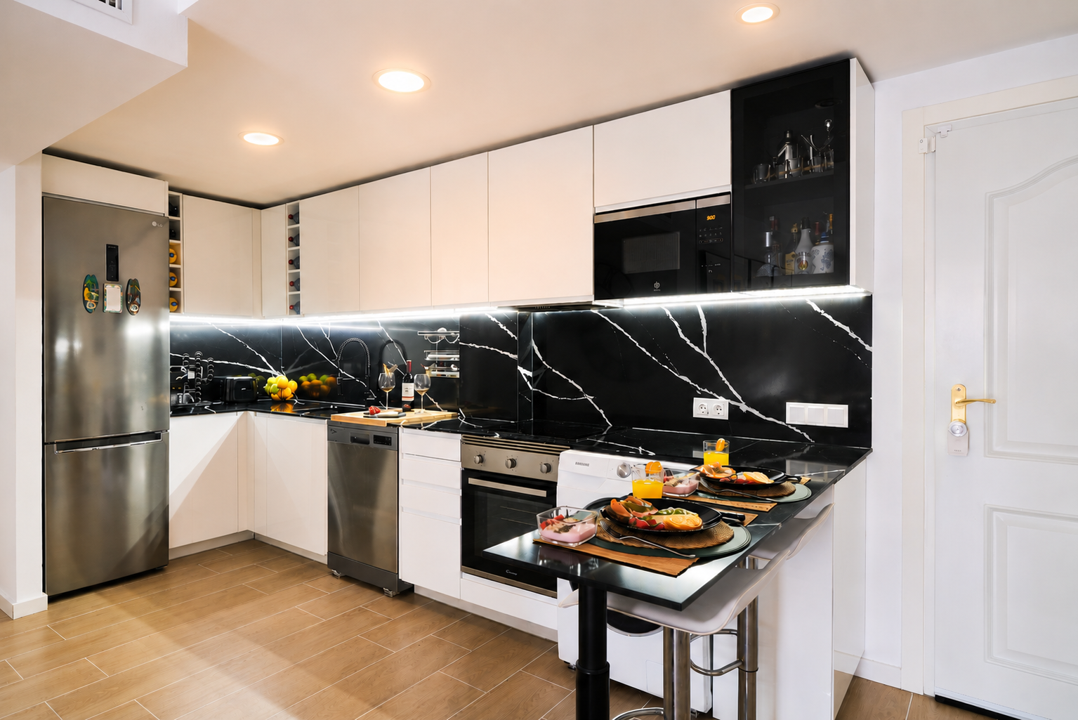 Modern, fully equipped kitchen with high-end appliances, elegant black quartz backsplash, and everything you need for a comfortable stay.