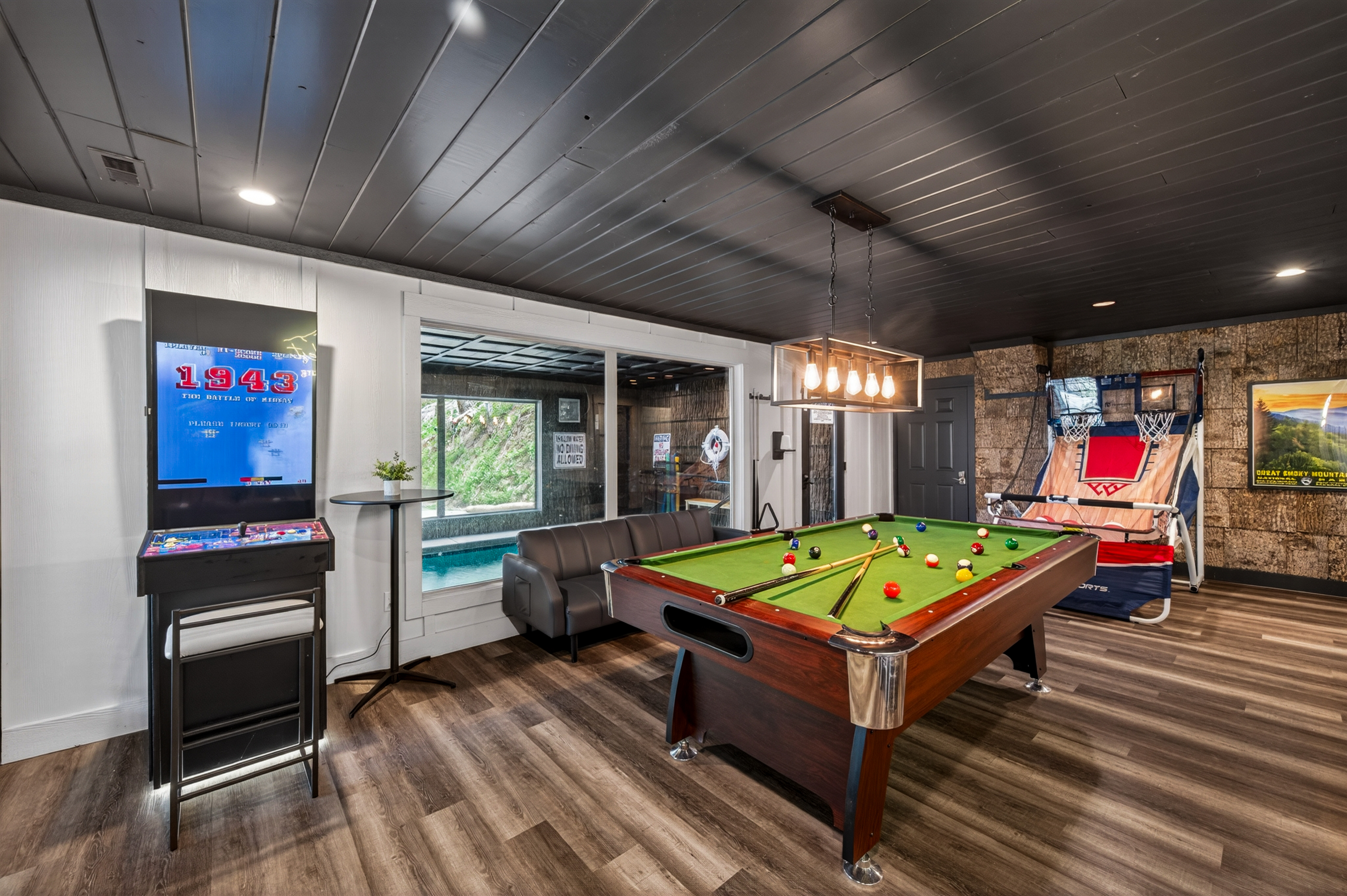 Pool table, video games and basketball. Indoor swimming pool room (self-locking door and alarm) on other side of glass from game room.