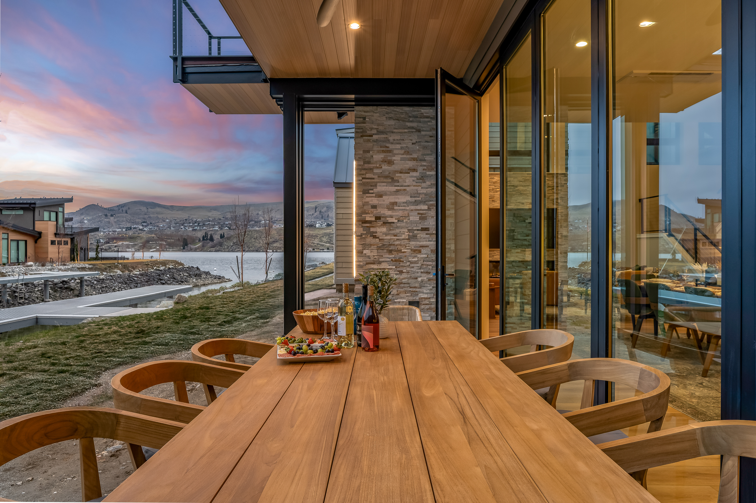 Lake views, outdoor table sliding glass wall to bring in the outdoors in, and glowing lakefront sunsets