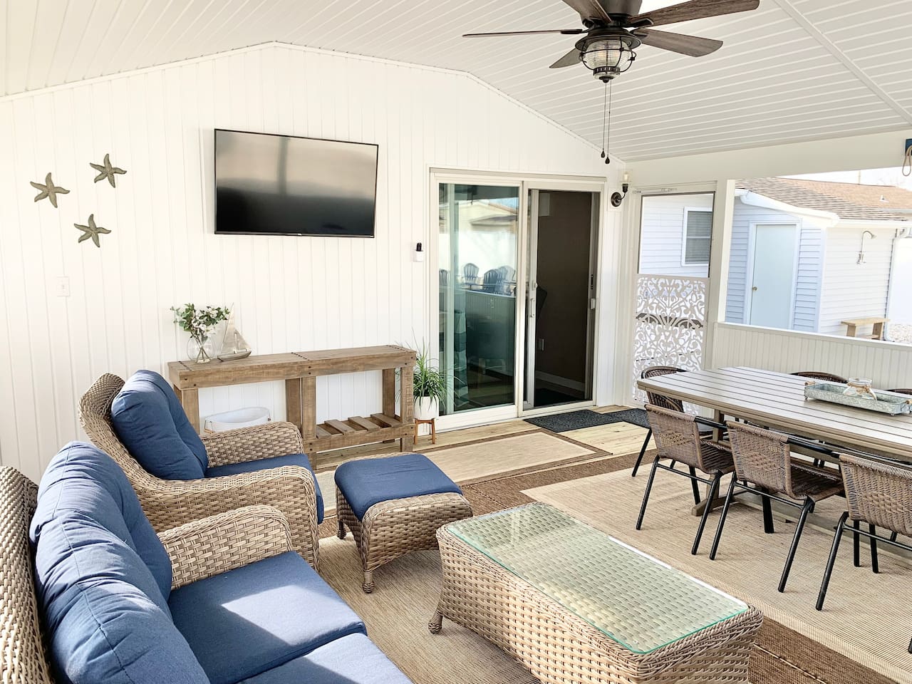 Relax in our bright screened in porch, featuring comfortable wicker seating, a flat-screen TV, and a full dining table. Perfect for morning coffee or evening games, this airy space offers a seamless blend of indoor comfort and outdoor vibes.