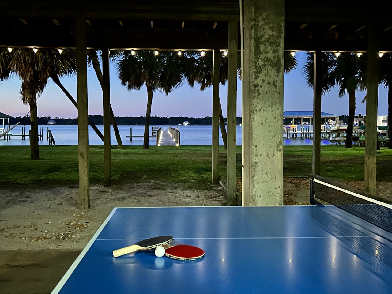 Enjoy a game at the outdoor ping-pong table with a stunning bayside view, perfect for family fun.
