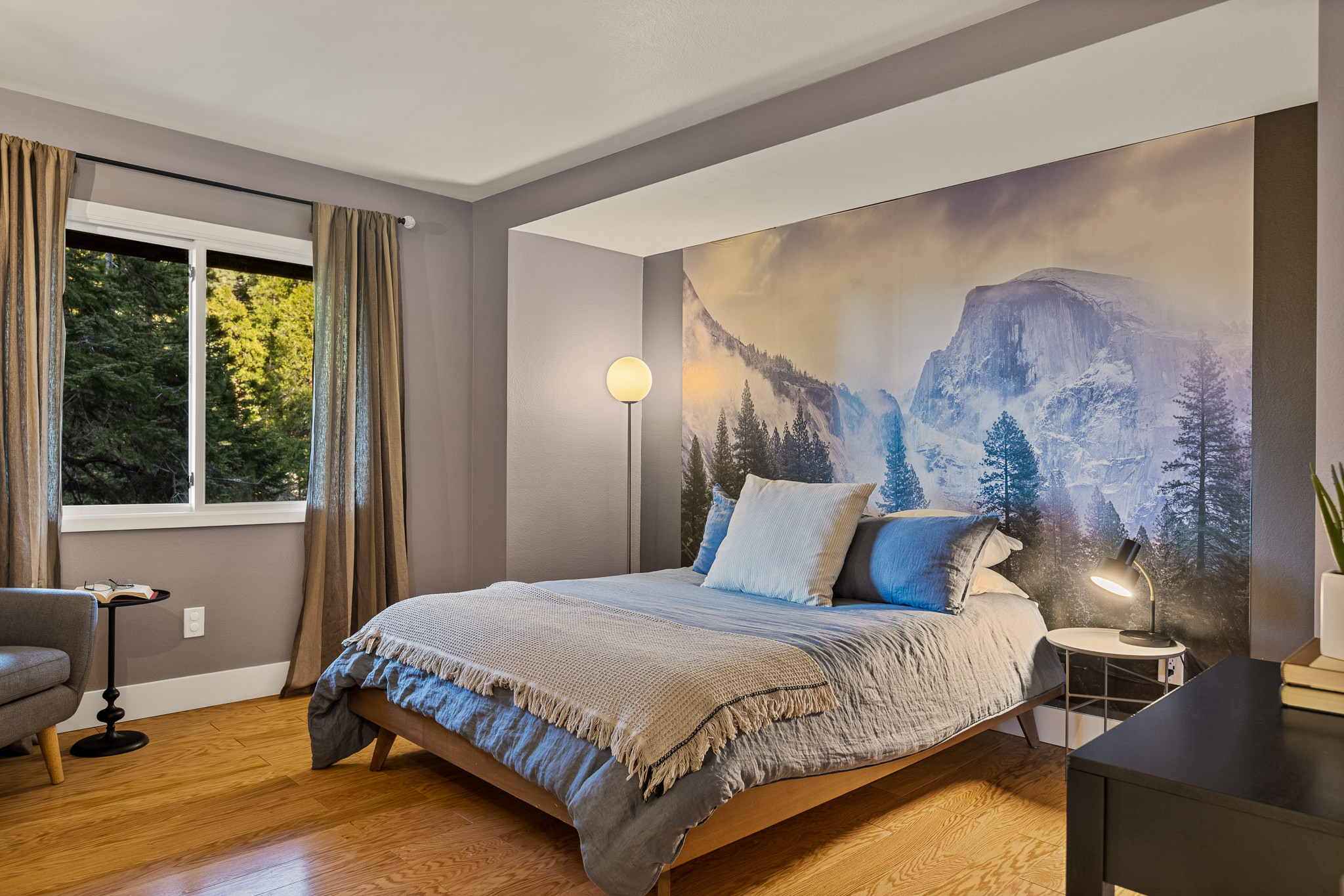 Bedroom 1: Retire for the night to rest and relax with a scenic backdrop of Yosemite National Park. (Queen Bed)
