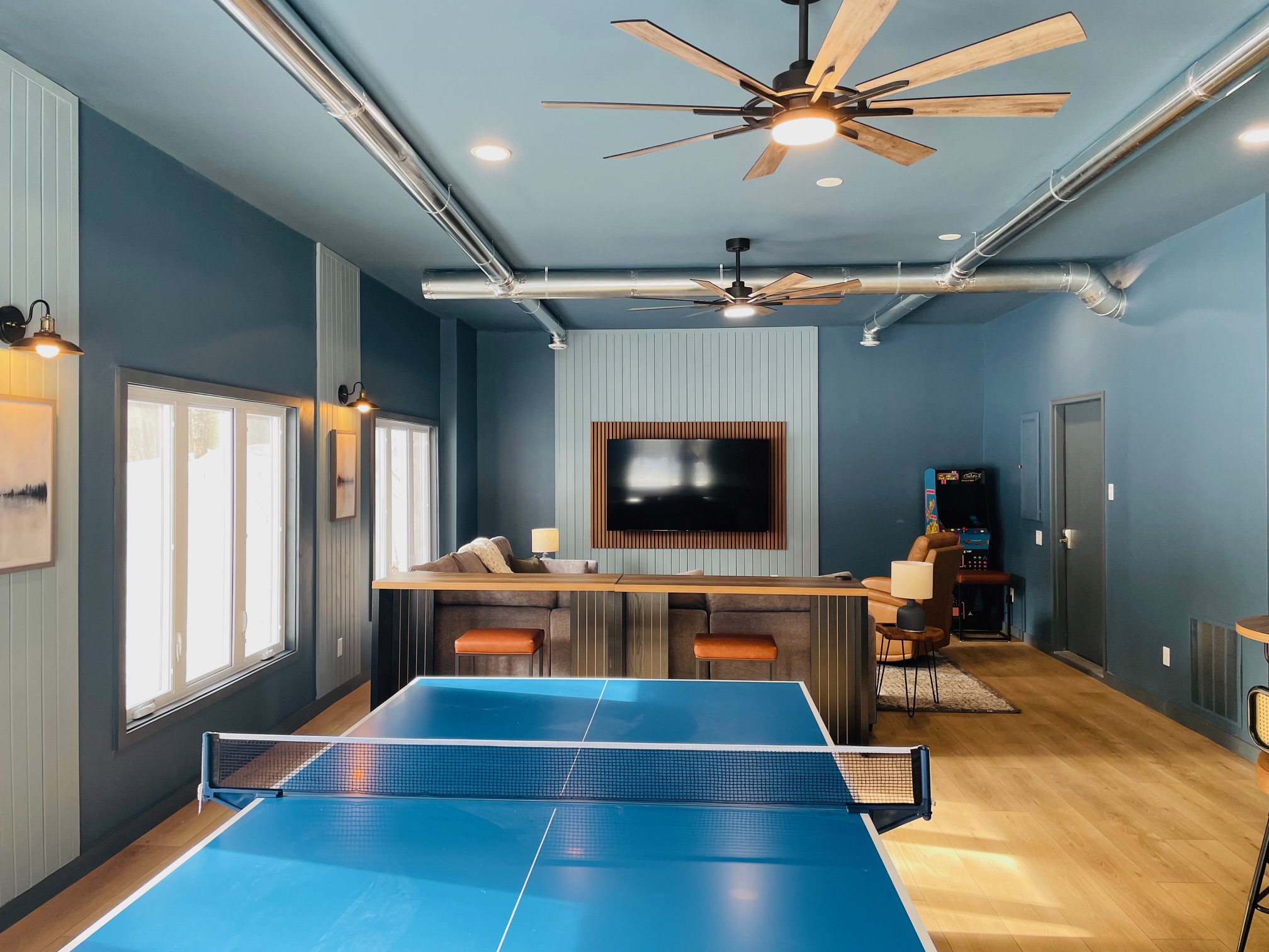 800 sq. ft. game/movie room with 2 arcades, ping pong table, Pop-a-Shot basketball and 75" TV with comfy sectional sofa and recliner.