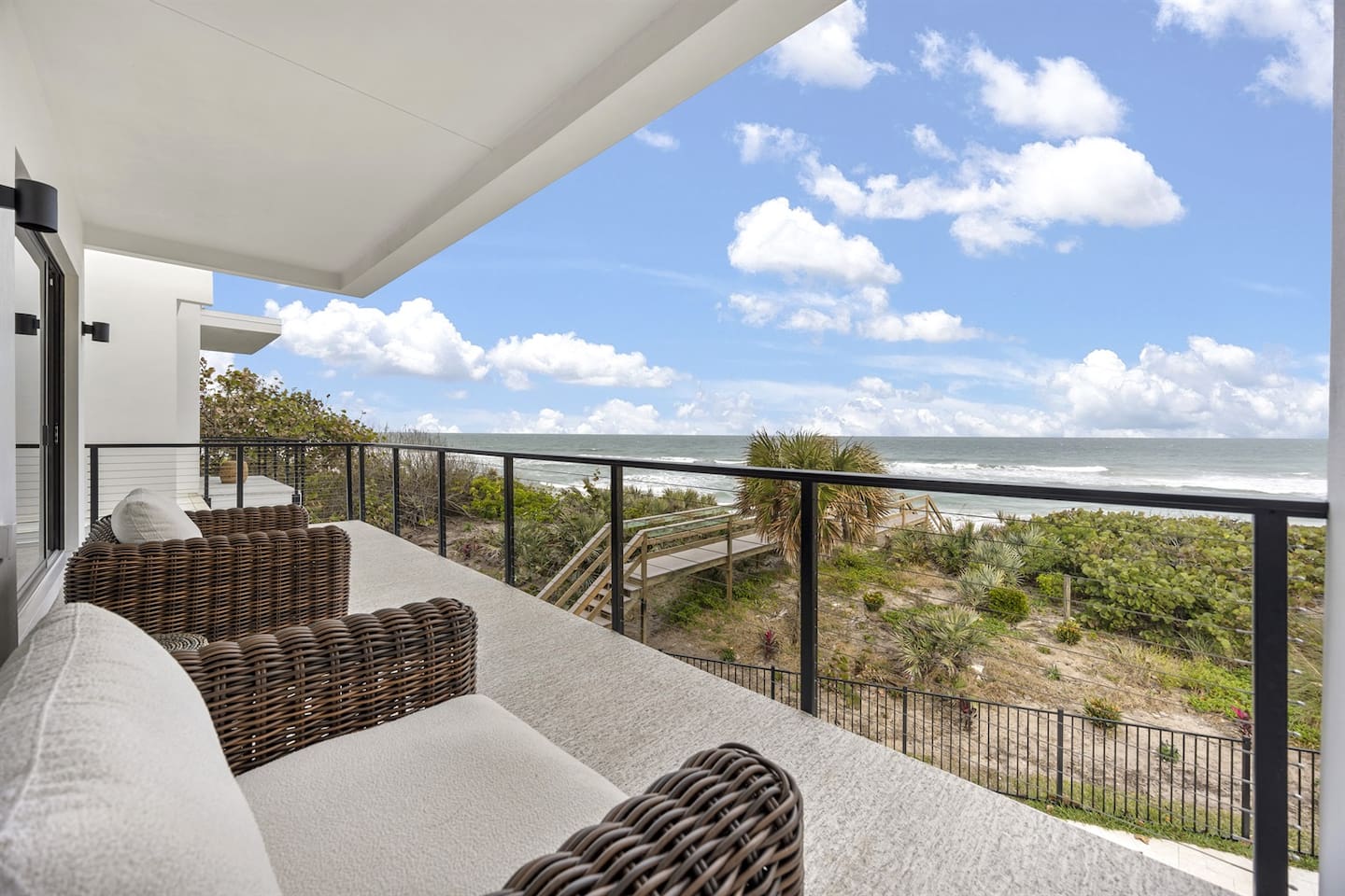 Relax on the comfortable chair on the balcony, perfectly positioned to offer stunning views of the surrounding landscape, making it the ideal spot to unwind and enjoy the beauty of the outdoors