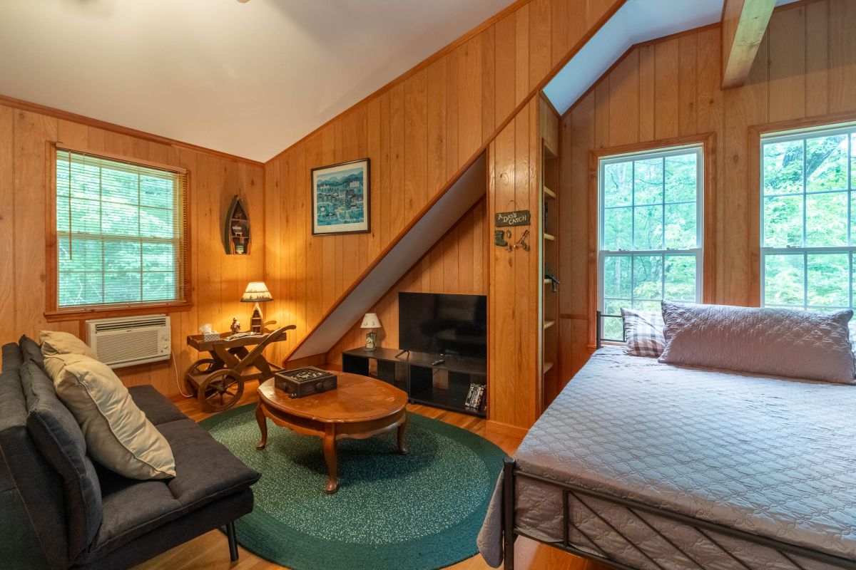 Room Retreat: Discover a charming space with wood accents, cozy seating, and a peaceful view!

