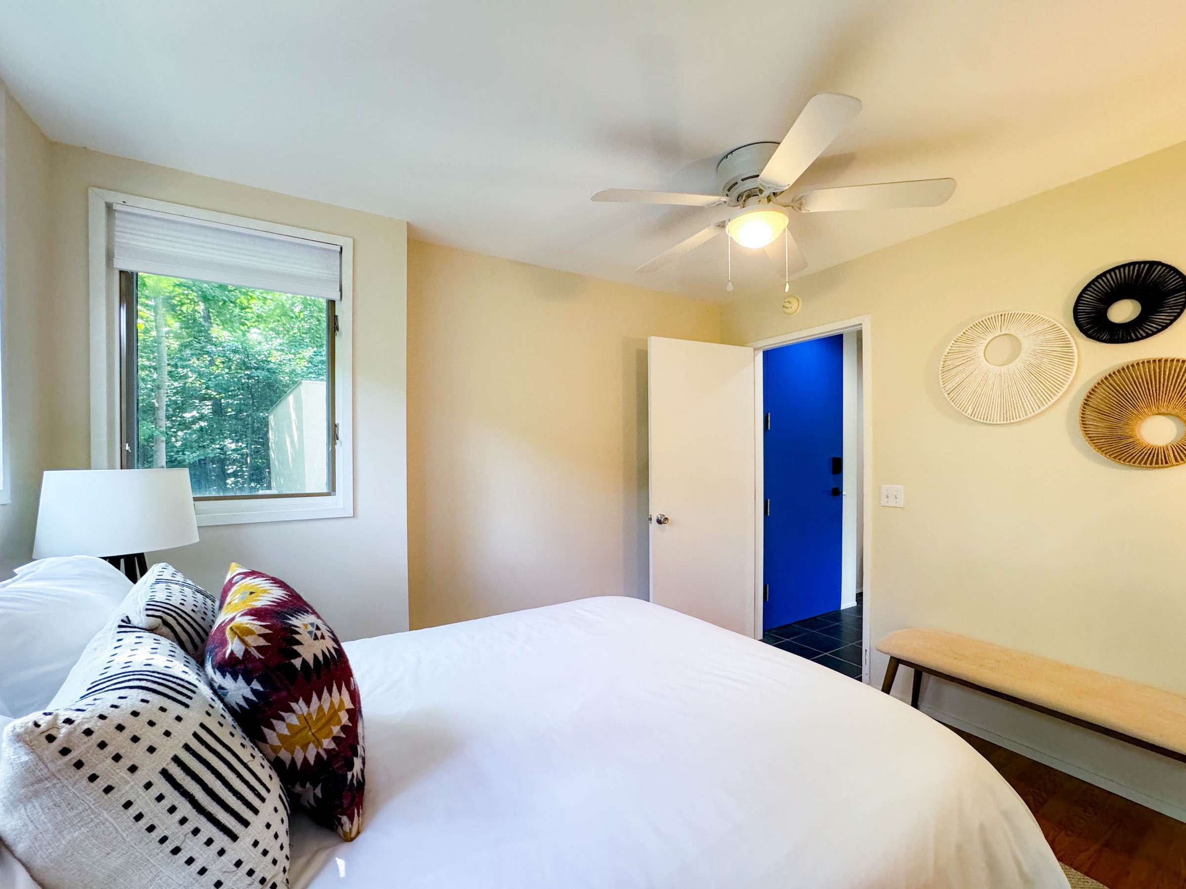 The main level bedroom features a comfy queen size bed and just inside of the entry door hallway.