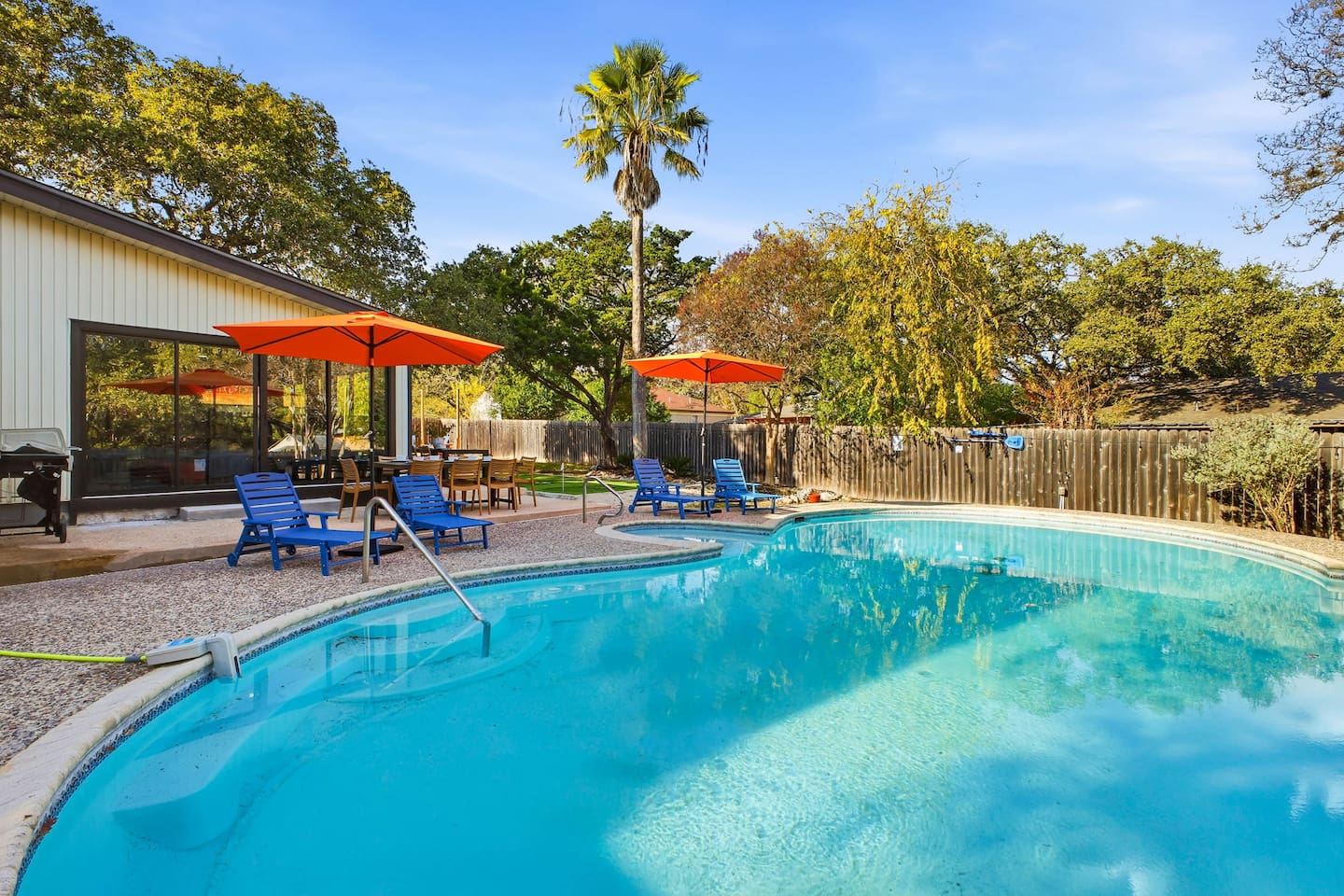 Large heated pool with lounge chairs for sunbathing and relaxation