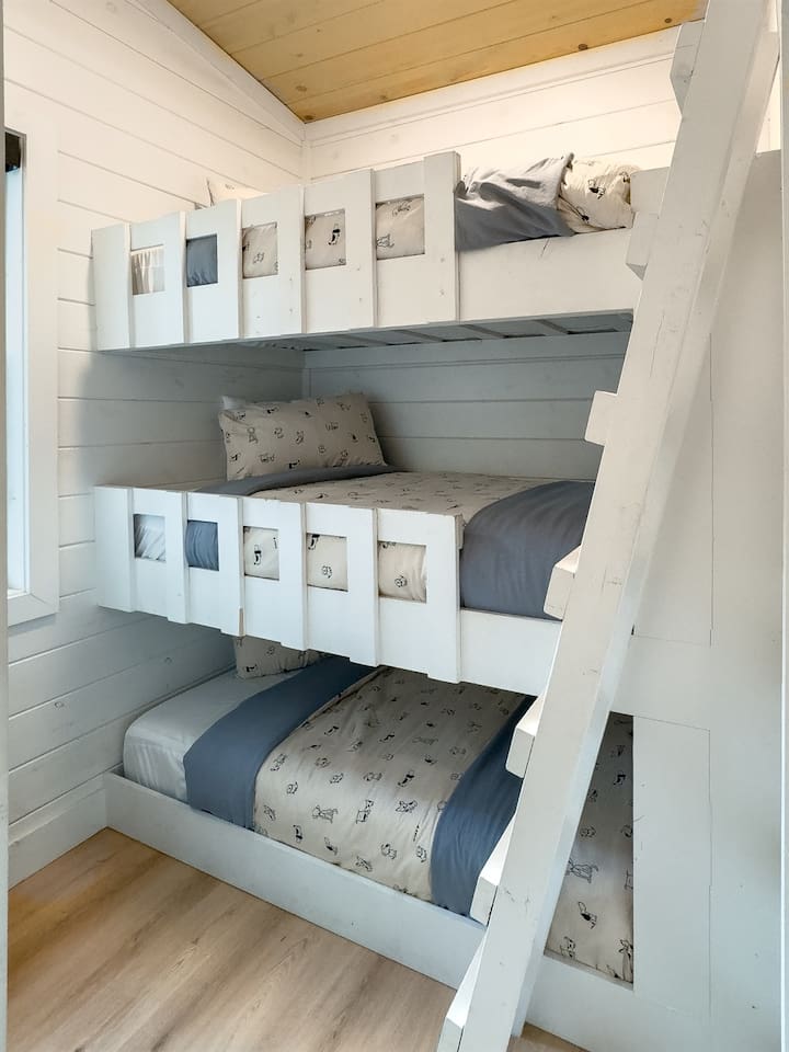 The bunk room is a dream for kids (or playful adults), with triple twin beds and space to relax, recharge, or tell ghost stories.