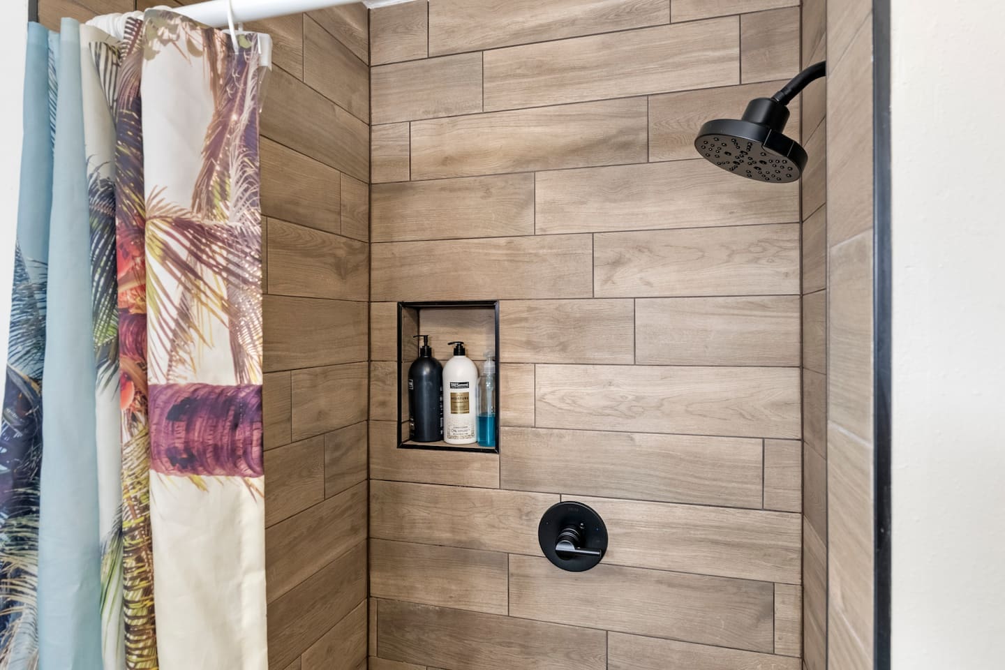 Guest Room suite with 1-queen bed. Beach Wagon themed room and private bathroom. 