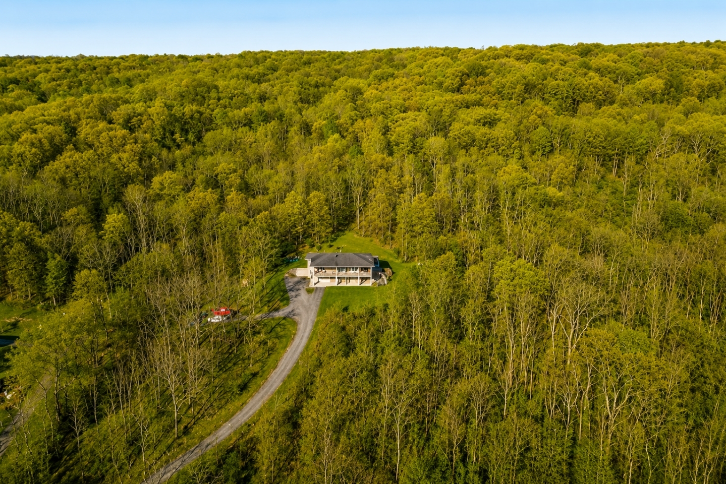 Discover this secluded lakeside haven, nestled amidst verdant foliage with sweeping views, offering privacy and natural beauty for a tranquil escape.
