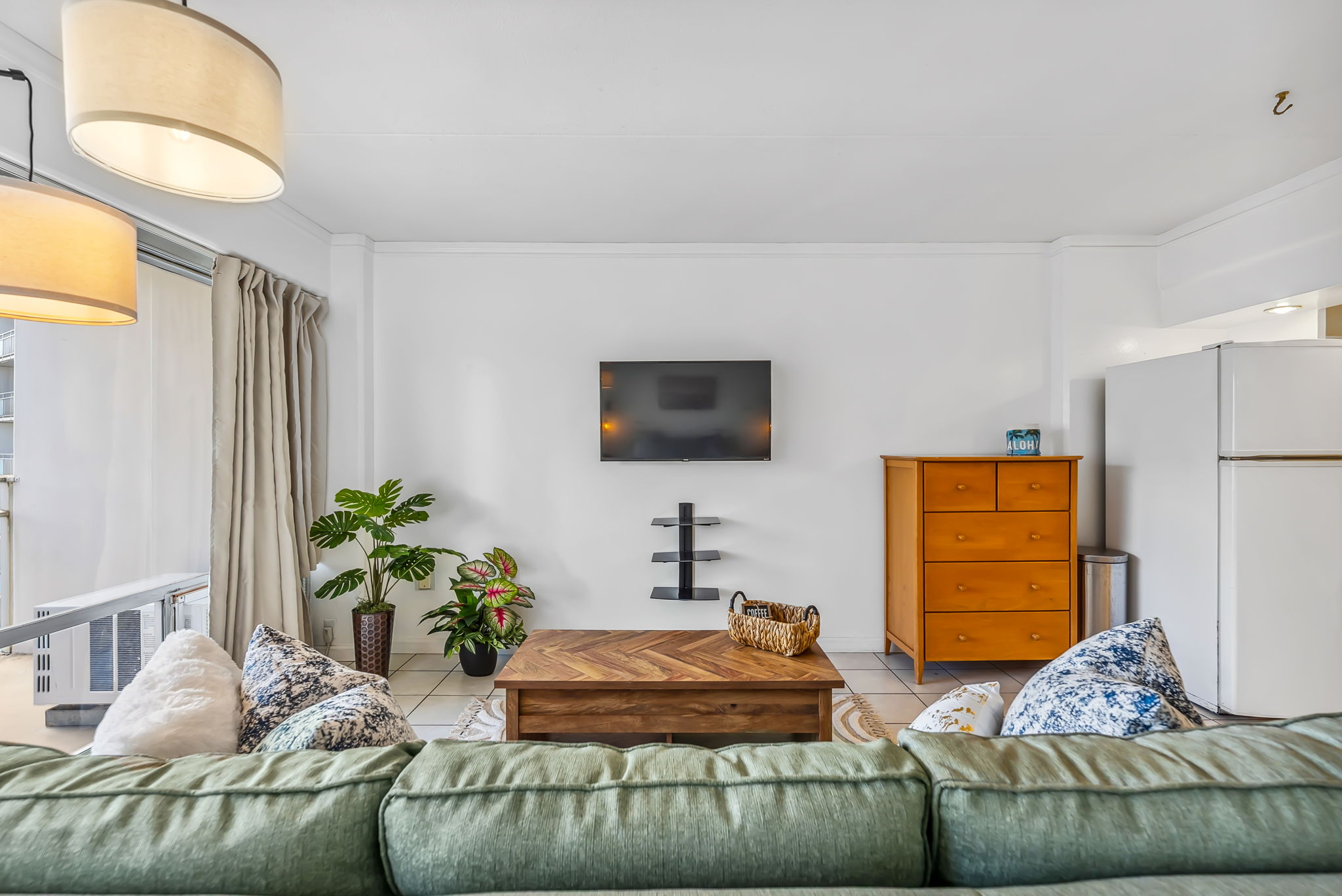 Bedroom view into living area with flat screen TV