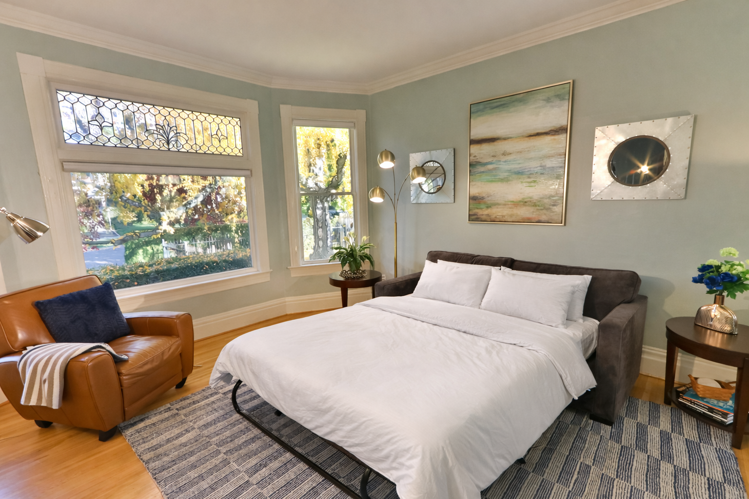 Great room with pull-out couch, sleeps 1-2 guests. Original pocket doors can be closed off for additional privacy.