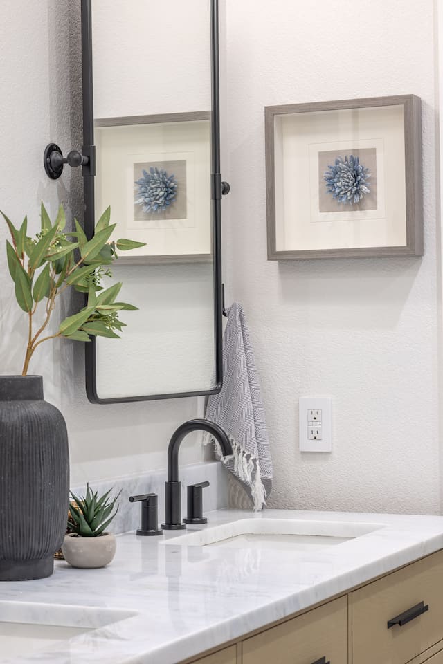 The shared hallway bathroom features marble countertops, modern fixtures, and warm wood cabinetry. Located between Bedroom 1 and Bedroom 2, this bathroom is easily accessible from Bedroom 3 and the main living spaces.