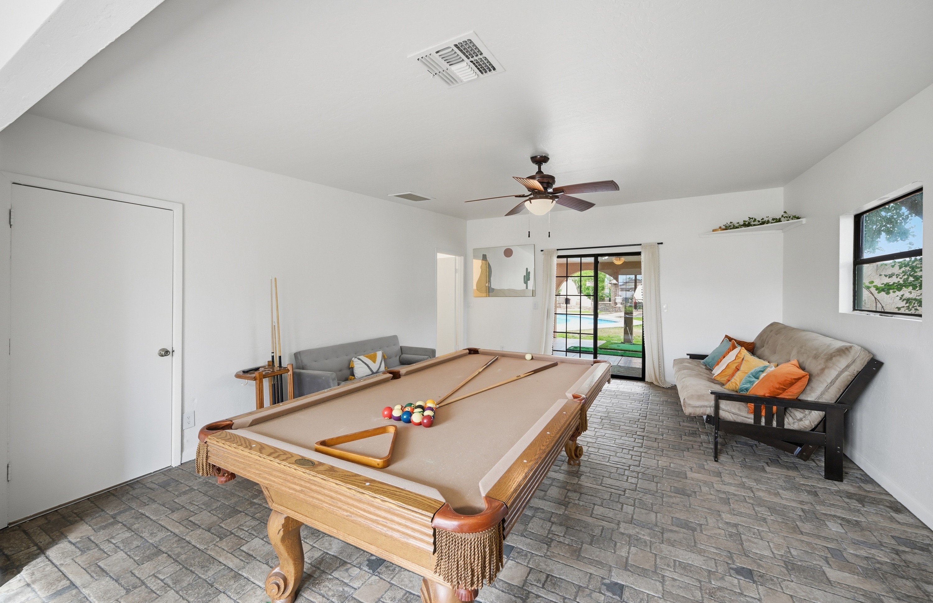 This game room features a full-size pool table, cozy lounge seating, and warm Southwestern charm for hours of laid-back entertainment.