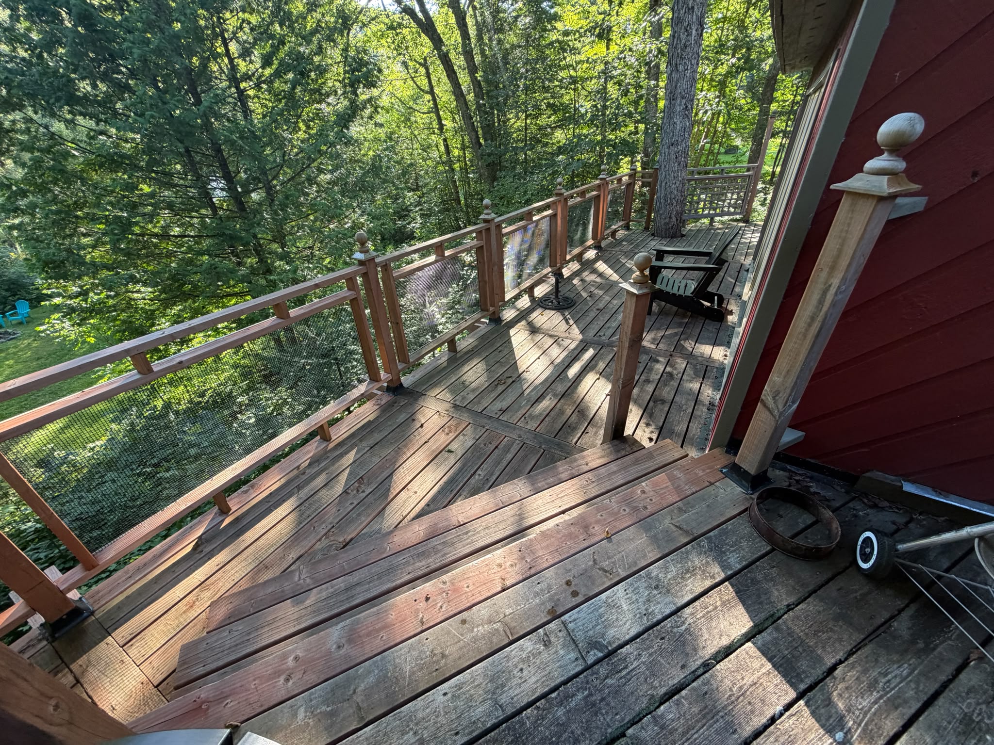 Cottage wrap-around deck with fire pit in distance