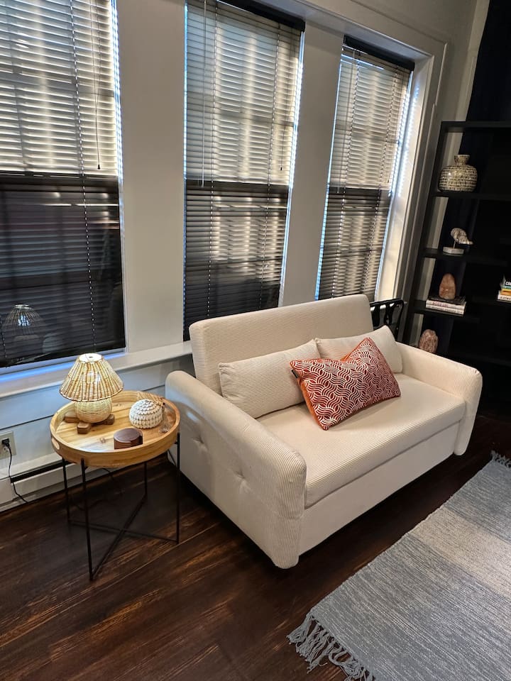 Sitting area with pull out futon in the Boho Room. Lots of natural light. 