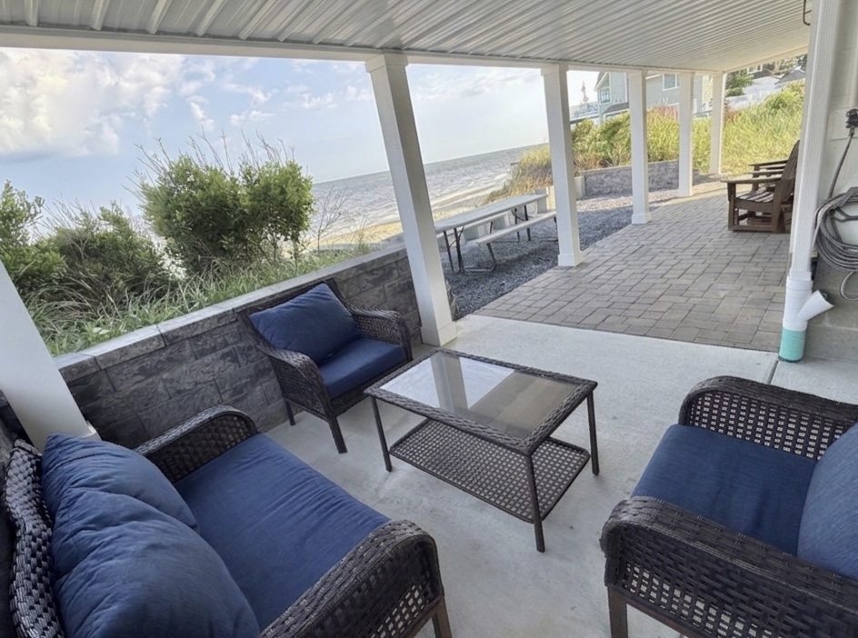Relax and unwind on our private, covered patio. Featuring comfortable outdoor seating and breathtaking views of the bay, this is the perfect spot to enjoy your morning coffee or watch the sunset after a day at the beach.