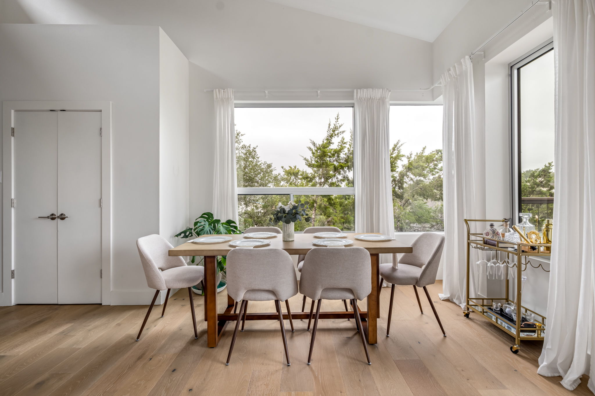 Bright dining area surrounded by windows and scenic views