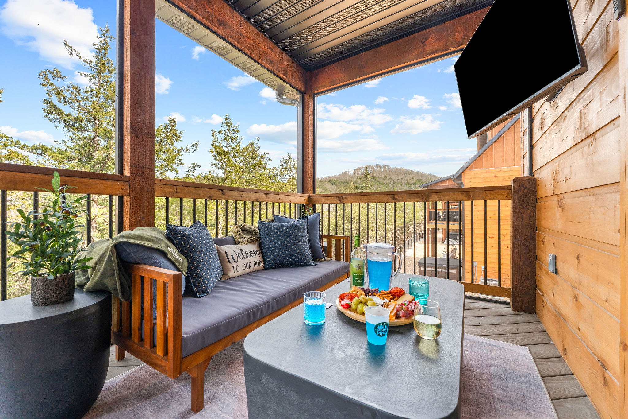 The main level deck has a screened in area, comfy seating and a large screen smart TV for watching the big game or holiday parade!